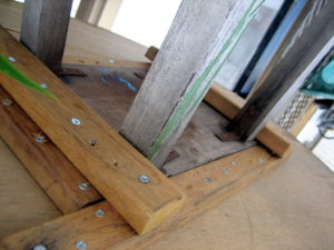 Close-up of the stool attachment. The stool wasn't directly screwed into the table. This way, it can be removed and used a stool if need be.